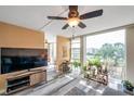 Sunlit living room featuring large windows with waterfront views and modern gray flooring at 7400 Sun Island S Dr # 206, South Pasadena, FL 33707