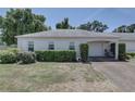 A single-story home with a well-maintained lawn, driveway, and attached one car garage at 8358 Candlewood Rd, Seminole, FL 33777