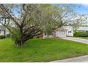 Charming one-story home features a well-maintained front lawn and an attached garage at 8600 Village Mill Row, Hudson, FL 34667