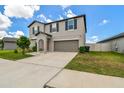 Two-story home featuring a well-manicured lawn and a two-car garage at 11504 Sage Canyon Dr, Riverview, FL 33578