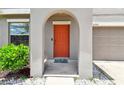Close-up of front door with an arched entry and a garden at 11504 Sage Canyon Dr, Riverview, FL 33578