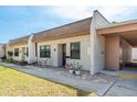 Welcoming exterior shot with quaint seating, colorful flowers, and easy access to the covered carport at 1472 Mission Hills Blvd # 24F, Clearwater, FL 33759