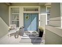 Welcoming front porch featuring double doors, decorative plants, and a striped welcome mat at 17124 Falconridge Rd, Lithia, FL 33547