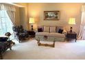 Elegant living room with plush seating, glass coffee table, and abundant natural light at 1765 Oak Pond Ct, Oldsmar, FL 34677