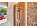 A close-up of a brown front door with gold hardware, unit number 18017, and textured stucco wall at 18017 Villa Creek Dr # 18017, Tampa, FL 33647