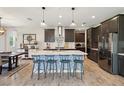 Modern kitchen with a large center island, stainless steel appliances, and stylish pendant lighting at 18219 Ramble On Way, Land O Lakes, FL 34638
