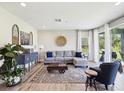 Bright living room featuring a comfortable sectional sofa and access to the outdoors at 18219 Ramble On Way, Land O Lakes, FL 34638