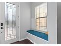 Charming entryway featuring a cozy window seat and decorative glass front door at 19407 Sweet Grass Way, Lutz, FL 33558