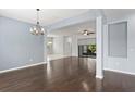 Open-concept living room with hardwood floors and view into adjoining rooms at 19407 Sweet Grass Way, Lutz, FL 33558
