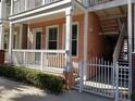 Charming multi-level townhome featuring a white fence and a private porch for relaxing outdoors at 2002 E 5Th Ave # 110, Tampa, FL 33605