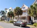 Charming multi-level townhomes with colorful exteriors, balconies, and lush tropical landscaping in a sunny neighborhood at 2002 E 5Th Ave # 110, Tampa, FL 33605
