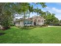 Beautiful home with tropical landscaping, offering a glimpse of its facade and well-maintained surroundings at 206 Corbett St, Belleair, FL 33756