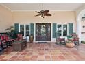 Welcoming front porch with tiled flooring, rocking chairs, and a decorative door, creating a cozy outdoor space at 206 Corbett St, Belleair, FL 33756