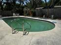 Refreshing backyard pool surrounded by a concrete deck and mature landscaping at 2154 Briarway Dr, Clearwater, FL 33763