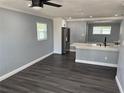 Open floor plan showing updated kitchen with stainless steel appliances and gray tone walls at 2205 N Grady Ave, Tampa, FL 33607