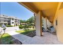 Exterior view showcasing community landscaping, manicured bushes, and seating area at 2231 Utopian E Dr # 117, Clearwater, FL 33763