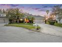 Single-Gathering home with well-manicured lawn and mature landscaping at 27338 Hollybrook Trl, Wesley Chapel, FL 33544