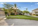 Beautiful single-Gathering home features mature landscaping and a well-manicured lawn at 27338 Hollybrook Trl, Wesley Chapel, FL 33544
