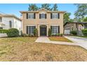 Charming two-story home with a well-manicured lawn, brick walkway, and symmetrical window shutters at 3114 W Barcelona St, Tampa, FL 33629