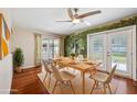 Bright dining room with wood floors, french doors to patio, and serene nature mural at 505 S Larry Cir, Brandon, FL 33511