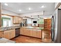 Bright kitchen featuring wooden cabinets, stainless steel appliances, and granite countertops at 505 S Larry Cir, Brandon, FL 33511