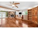 Spacious living room with hardwood floors, a stone fireplace, and built-in bookshelves at 505 S Larry Cir, Brandon, FL 33511