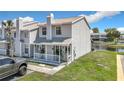 Two-story townhouse with covered porch, neat landscaping, and lakeside view, perfect for relaxed living at 5316 Ladywell Ct, Tampa, FL 33624