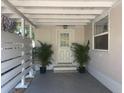 Covered patio featuring a white door and potted plants, offering a cozy and inviting outdoor space at 5725 2Nd N Ave, St Petersburg, FL 33710