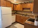 Functional kitchen features oak cabinetry, laminate countertops, and white appliances at 5725 2Nd N Ave, St Petersburg, FL 33710