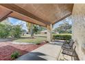 Covered front porch area, perfect for enjoying the outdoors and the landscaped yard at 614 Sandalwood Dr, Plant City, FL 33563