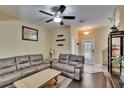 Comfortable living room featuring modern decor, neutral paint, hardwood flooring, and ample natural light at 6918 Frog Pocket Pl, Tampa, FL 33616