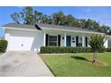 Lovely single-story home featuring a well-manicured lawn, an attached garage, and a welcoming blue front door at 7229 Northbridge Blvd, Tampa, FL 33615