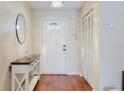 Bright foyer with hardwood floors and decorative table at 7402 America Way, New Port Richey, FL 34654