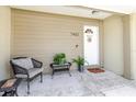 Inviting front porch with seating area and decorative accents at 7402 America Way, New Port Richey, FL 34654