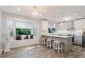 Eat-in kitchen with a large window, pendant lights, and lots of counter space at 7402 America Way, New Port Richey, FL 34654