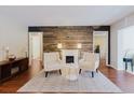 Stylish living room with fireplace and wood accent wall at 7402 America Way, New Port Richey, FL 34654