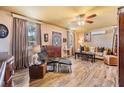 Inviting living room featuring wood-look flooring, lots of natural light and a ceiling fan at 7603 N 53Rd St, Tampa, FL 33617