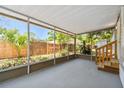 A screened-in porch offers views of the fenced-in backyard at 850 Center Ave, Brandon, FL 33511