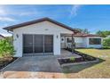 View of a lovely house with well-maintained landscaping, a paved walkway, and a single-car garage at 9010 Bonnet Way, Weeki Wachee, FL 34613