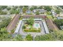 Aerial view of condo complex with pool, parking, and manicured green spaces at 9851 113Th St # 206, Seminole, FL 33772