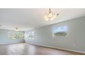 Bright living room with wood floors, ceiling fan, and multiple windows at 9851 113Th St # 206, Seminole, FL 33772