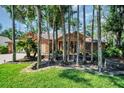 Home with lush landscaping and mature trees in a tranquil setting at 10 Greenhaven Cir, Oldsmar, FL 34677