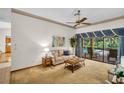 Bright living room with access to a screened in pool area at 10 Greenhaven Cir, Oldsmar, FL 34677