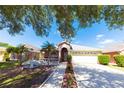 Charming single Gathering home featuring a well-manicured lawn, two-car garage, and mature landscaping at 10918 Lake Andover Blvd, Tampa, FL 33624