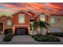 Charming townhome featuring a two-car garage, landscaped front yard, and a private entrance at 11 Franklin S Ct # C, St Petersburg, FL 33711
