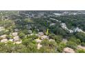 Aerial view of a neighborhood featuring mature trees, townhomes, and a pond at 11802 Foxrun Ln, Temple Terrace, FL 33617