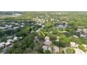 Wide aerial view showing the property's proximity to a pond and nearby roadways at 11802 Foxrun Ln, Temple Terrace, FL 33617