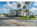 Well maintained building with palm trees, landscaping and ample parking at 1235 S Highland Ave # 2-207, Clearwater, FL 33756