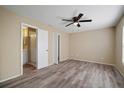 Bright bedroom features modern ceiling fan, neutral walls, and ensuite bathroom with updated fixtures at 12419 Dawn Vista Dr, Riverview, FL 33578