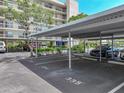 Covered parking offering shade with nearby landscaping and building access at 1332 Pasadena S Ave # 503, South Pasadena, FL 33707